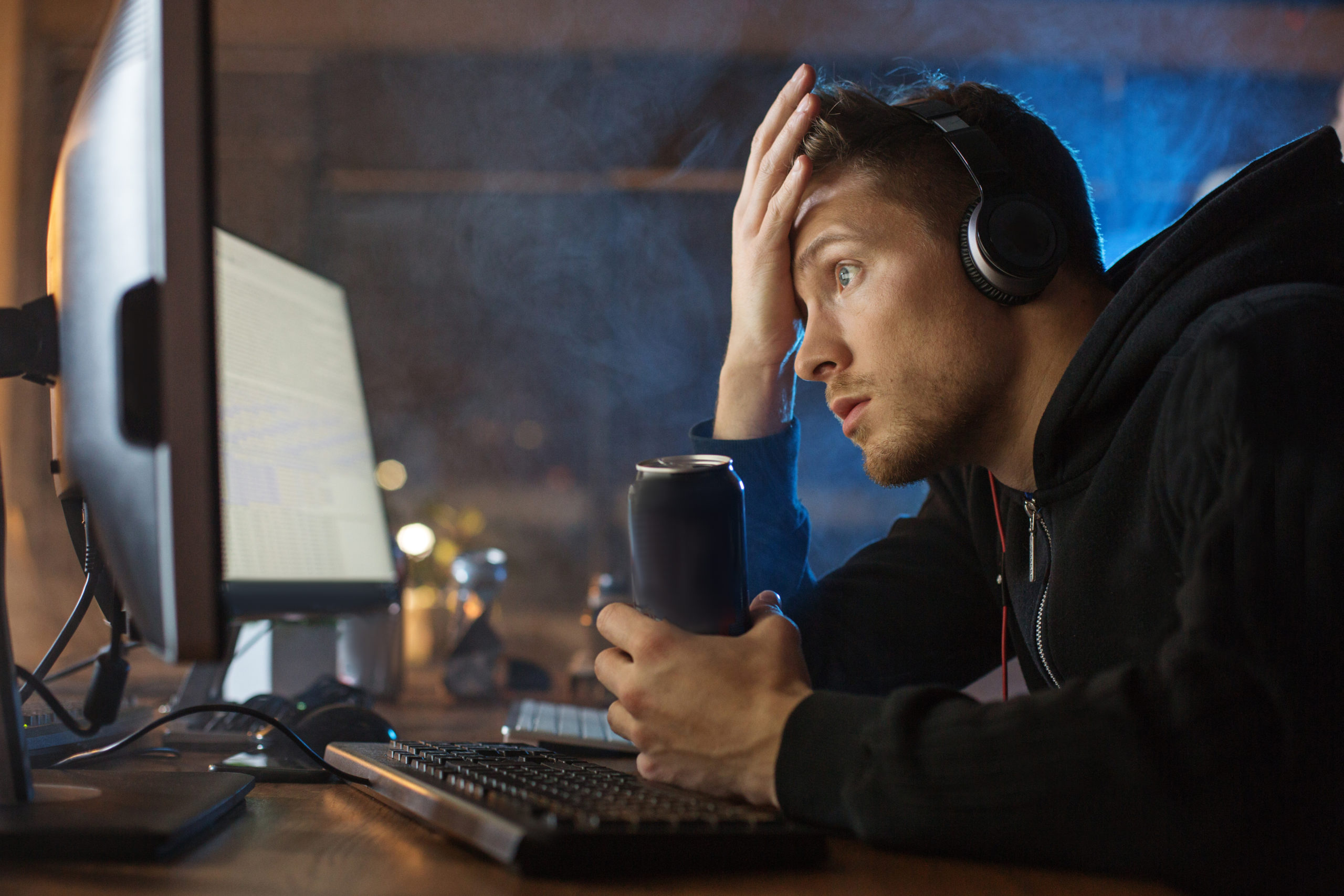Man frustrated by outdated legacy software on computer 