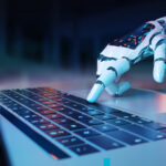 Robot hand pressing keyboard laptop