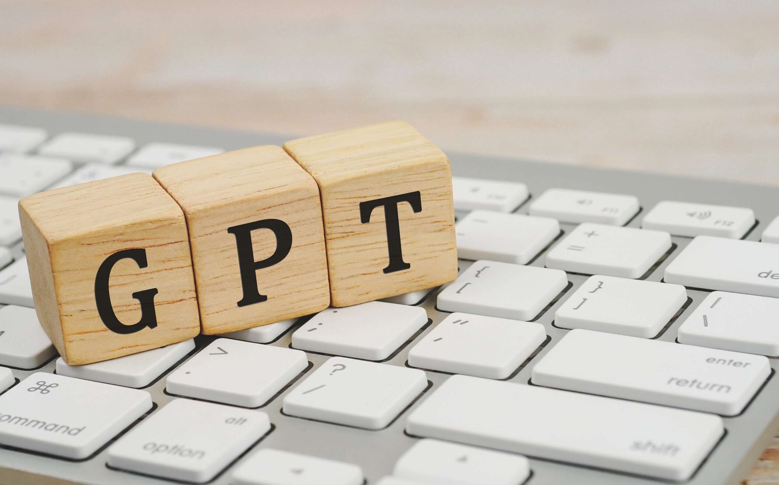 GPT spelled in wooden blocks on a keyboard