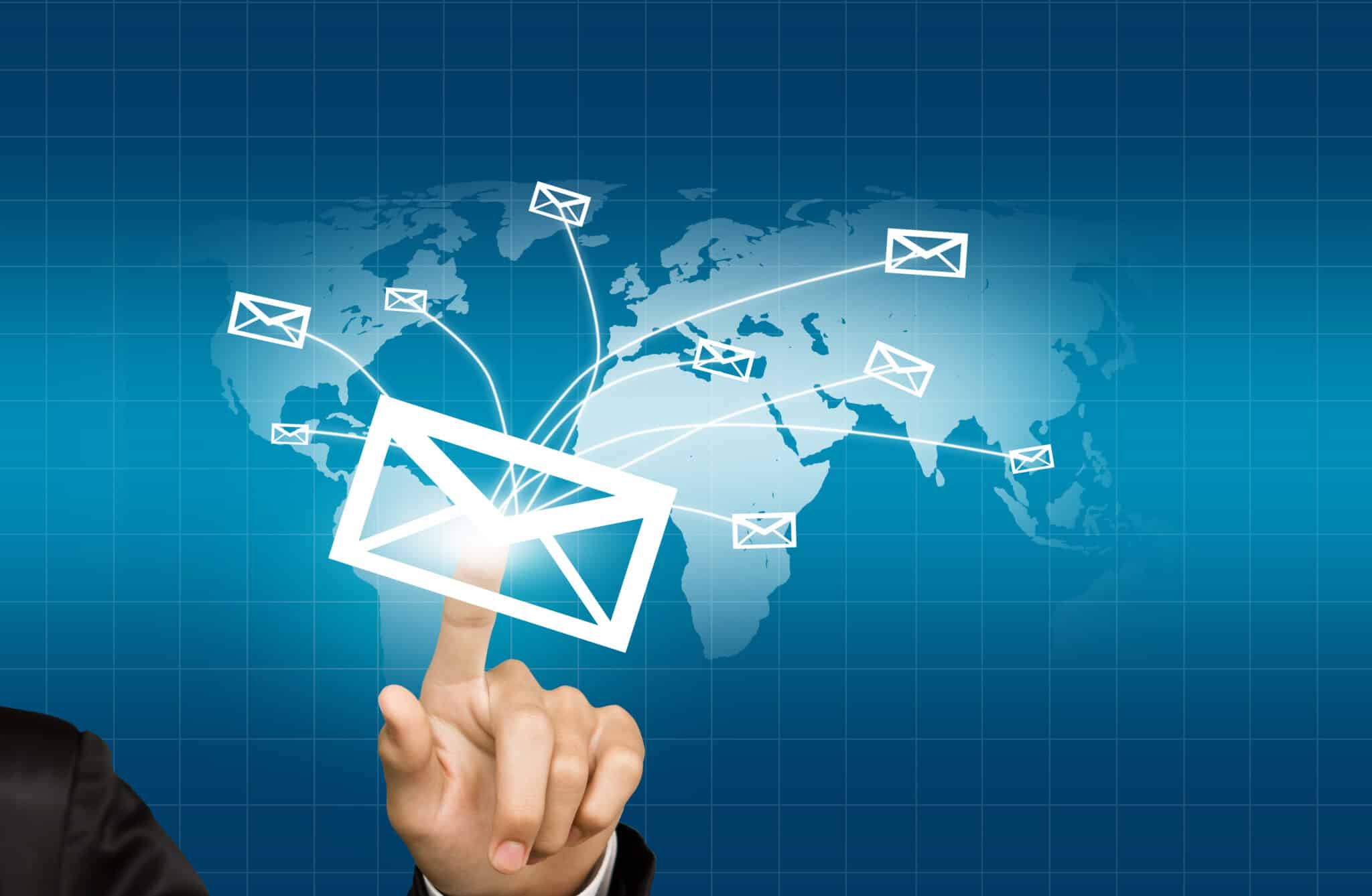 Hands pressing an email delivered on world map