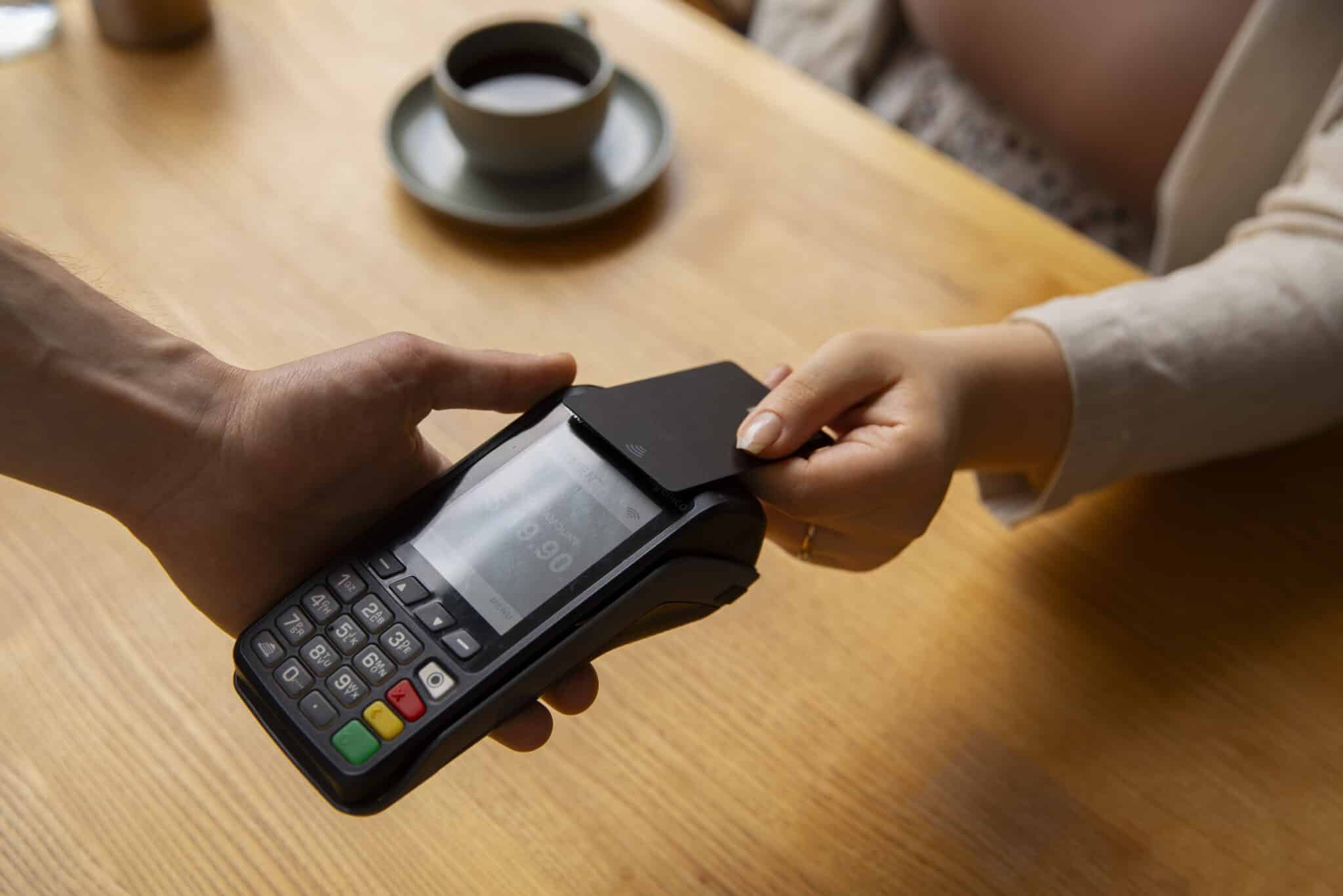 a customer tapping their card on a machine for payment